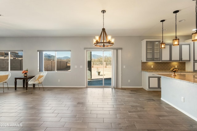 kitchen with a notable chandelier, decorative light fixtures, and backsplash