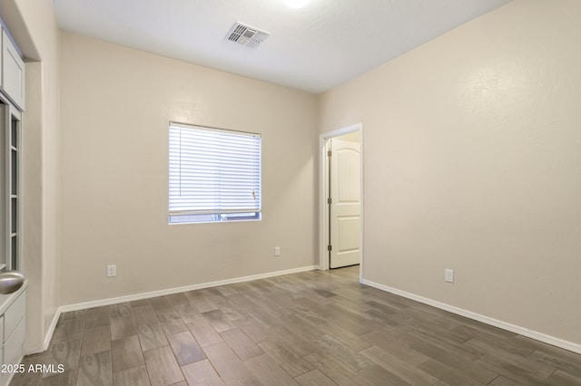 spare room with hardwood / wood-style floors