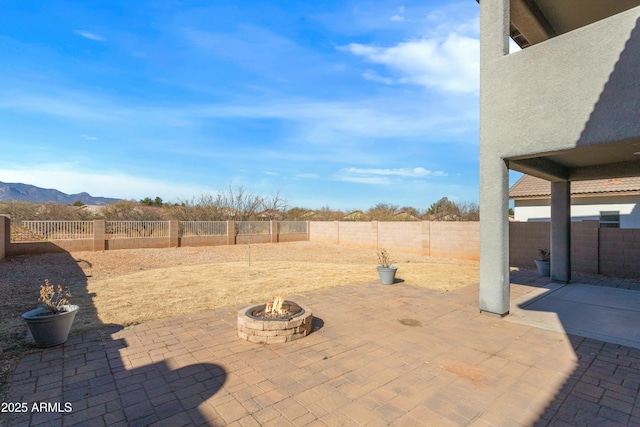 view of patio / terrace featuring a mountain view and an outdoor fire pit