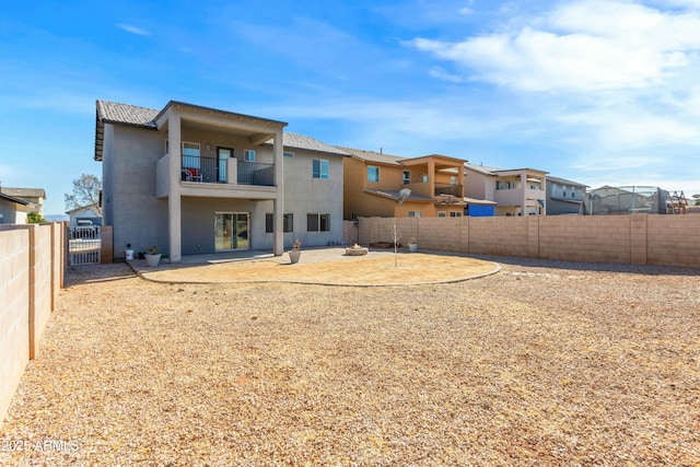 back of house featuring a patio and a balcony