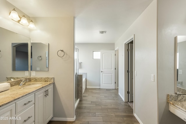 bathroom with an enclosed shower and vanity