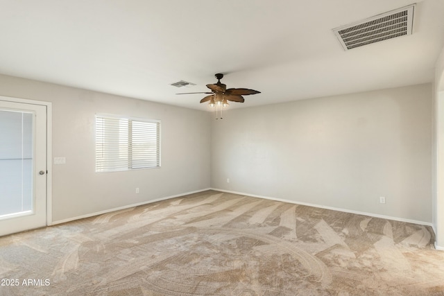 empty room with ceiling fan and light carpet