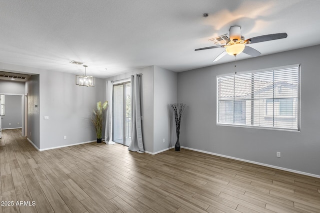2941 E Darrow St, Phoenix, AZ 85042 - unfurnished room featuring a chandelier, wood finished floors, ceiling fan, and fire sprinkler in ceiling
