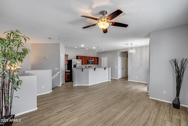 2941 E Darrow St, Phoenix, AZ 85042 - unfurnished living room with a ceiling fan, light wood-style flooring, recessed lighting, and a chandelier