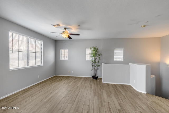 2941 E Darrow St, Phoenix, AZ 85042 - spare room featuring wood finished floors, a ceiling fan, and a smoke detector