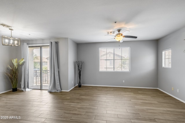 2941 E Darrow St, Phoenix, AZ 85042 - unfurnished room featuring a chandelier, wood finished floors, and ceiling fan
