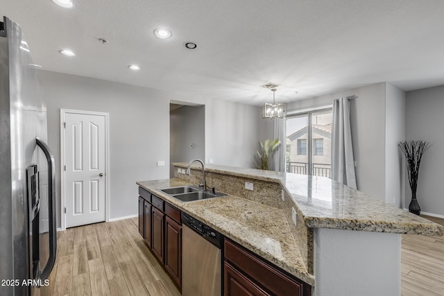 2941 E Darrow St, Phoenix, AZ 85042 - kitchen featuring stainless steel appliances, light wood-style flooring, a chandelier, recessed lighting, and a center island with sink