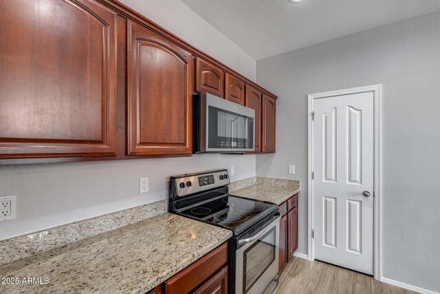 2941 E Darrow St, Phoenix, AZ 85042 - kitchen with stainless steel appliances, light wood-type flooring, and light stone countertops