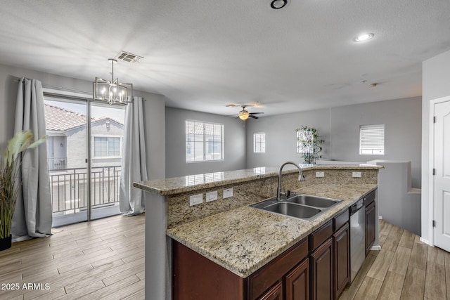 2941 E Darrow St, Phoenix, AZ 85042 - kitchen with light wood finished floors, a kitchen island with sink, dishwasher, ceiling fan, and hanging light fixtures