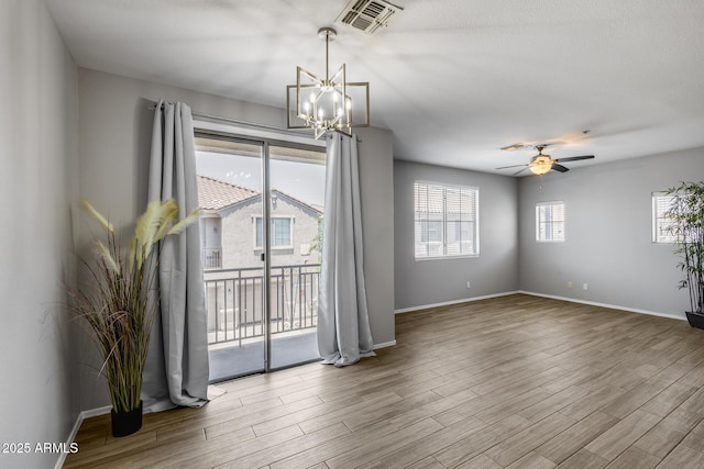 2941 E Darrow St, Phoenix, AZ 85042 - spare room with wood finished floors, a chandelier, and ceiling fan