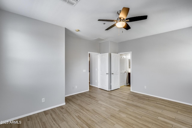 2941 E Darrow St, Phoenix, AZ 85042 - unfurnished bedroom with light wood-style floors, connected bathroom, and ceiling fan