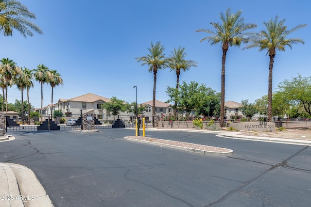 2941 E Darrow St, Phoenix, AZ 85042 - view of asphalt road with sidewalks, a residential view, a gate, and a gated entry