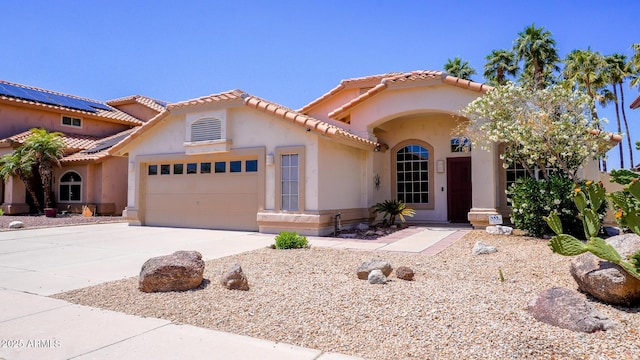 10952 S Desert Lake Dr, Goodyear, AZ 85338 - mediterranean / spanish house with an attached garage, stucco siding, a tile roof, and concrete driveway