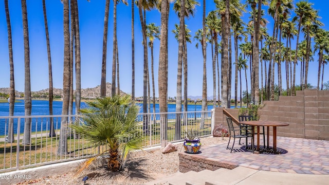 10952 S Desert Lake Dr, Goodyear, AZ 85338 - view of patio / terrace featuring fence and a water view