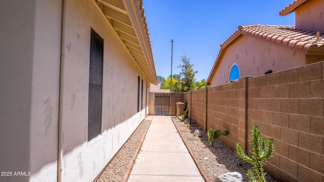 10952 S Desert Lake Dr, Goodyear, AZ 85338 - view of side of property featuring fence, a gate, and stucco siding