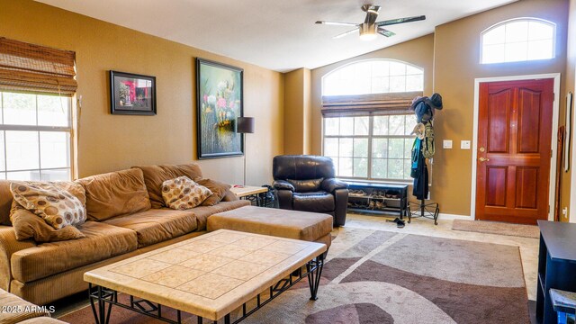 10952 S Desert Lake Dr, Goodyear, AZ 85338 - living room featuring baseboards, ceiling fan, a healthy amount of sunlight, and lofted ceiling