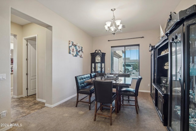 carpeted dining space with a notable chandelier