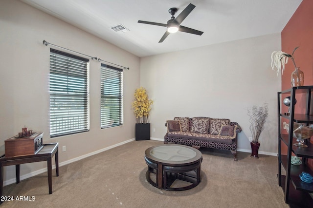 sitting room featuring light carpet and ceiling fan