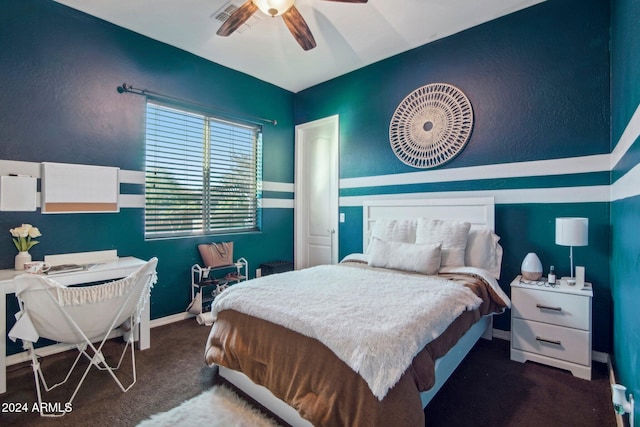 bedroom featuring ceiling fan and dark carpet