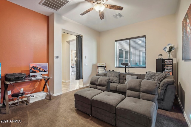 carpeted cinema room with ceiling fan