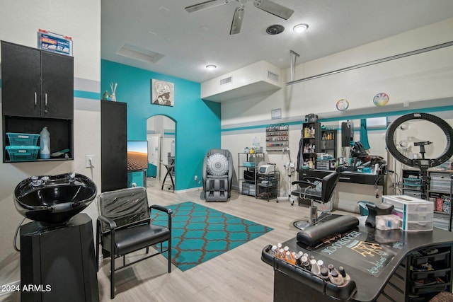 exercise room featuring light hardwood / wood-style floors and ceiling fan