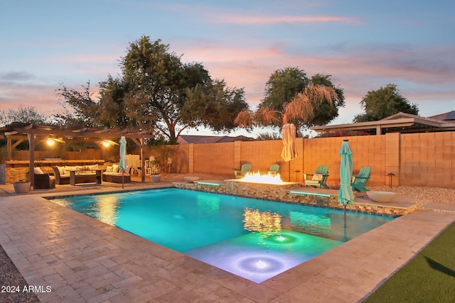 pool at dusk featuring a jacuzzi, a pergola, an outdoor living space with a fire pit, and a patio area