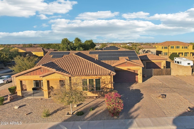 view of front of house featuring solar panels and a garage