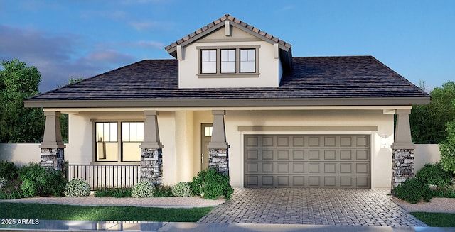 view of front of house featuring covered porch, stone siding, decorative driveway, and stucco siding