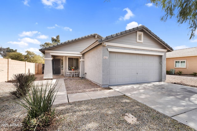 ranch-style house featuring a garage, a tile roof, fence, driveway, and stucco siding