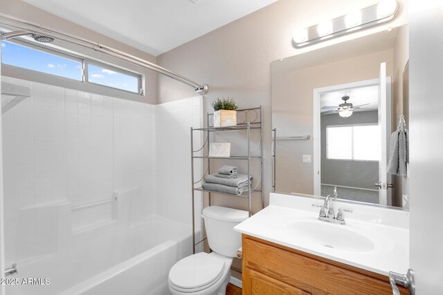 bathroom with a wealth of natural light, bathtub / shower combination, vanity, and toilet