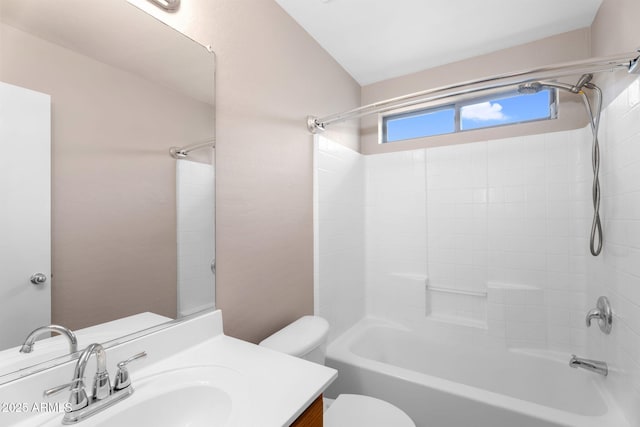 bathroom featuring washtub / shower combination, vanity, and toilet