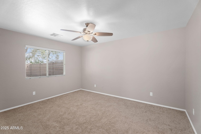 spare room with baseboards, visible vents, ceiling fan, and carpet flooring