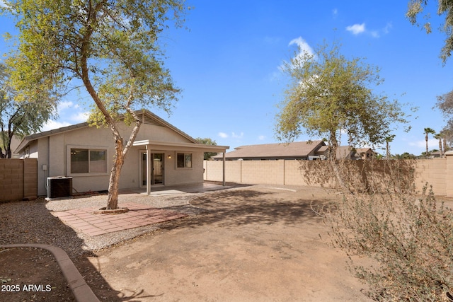 rear view of property with a patio area, a fenced backyard, and central AC unit