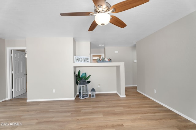 spare room featuring light wood-style flooring and baseboards