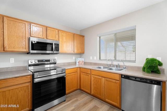 kitchen with light countertops, appliances with stainless steel finishes, and a sink