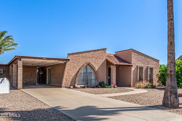 619 E Elaine St, Casa Grande, AZ 85122 - view of front of property with stucco siding, an attached carport, driveway, and brick siding