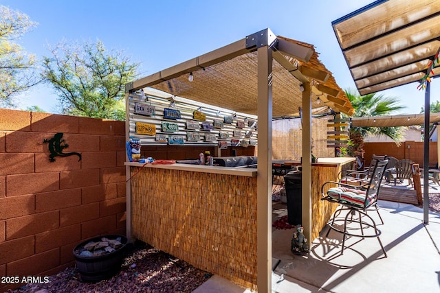 view of patio with an outdoor bar