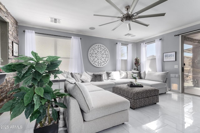 living room with ceiling fan and ornamental molding