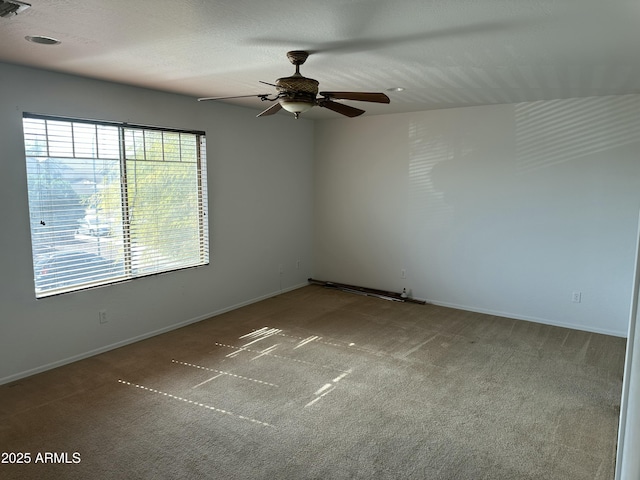 unfurnished room with ceiling fan, carpet floors, and a textured ceiling