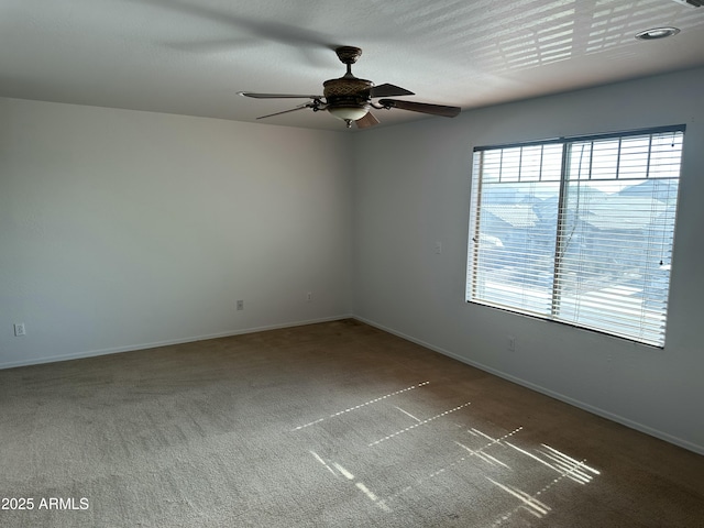 empty room featuring ceiling fan, carpet, and a textured ceiling