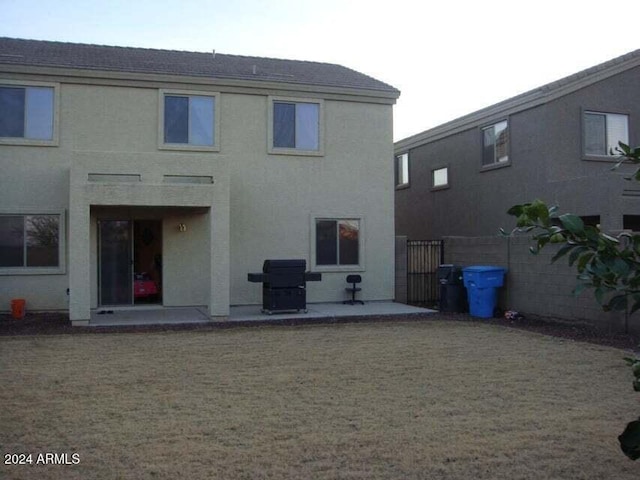 back of house with a yard and a patio area