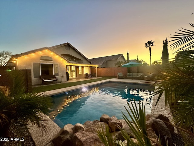 view of pool with a fenced in pool, an outdoor hangout area, a patio, and fence