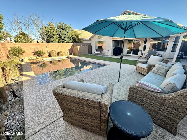 view of patio / terrace with an outdoor living space, area for grilling, a fenced backyard, and a fenced in pool