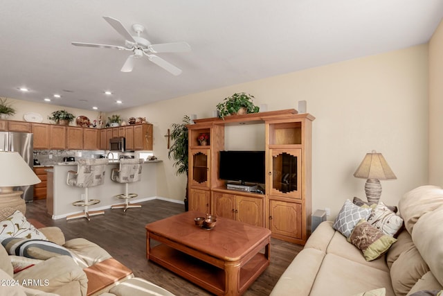 living room featuring ceiling fan and dark wood-type flooring