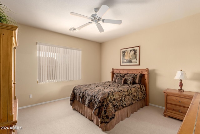 bedroom featuring light colored carpet and ceiling fan