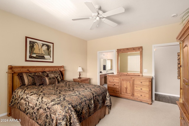 carpeted bedroom featuring ensuite bath and ceiling fan