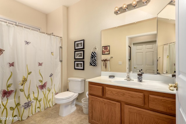 bathroom with tile patterned floors, vanity, and toilet