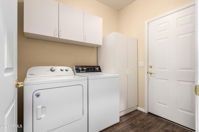 clothes washing area featuring cabinets, dark hardwood / wood-style floors, and washer and clothes dryer