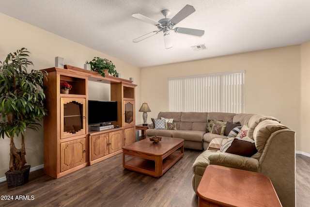 living room featuring a textured ceiling, dark hardwood / wood-style floors, and ceiling fan