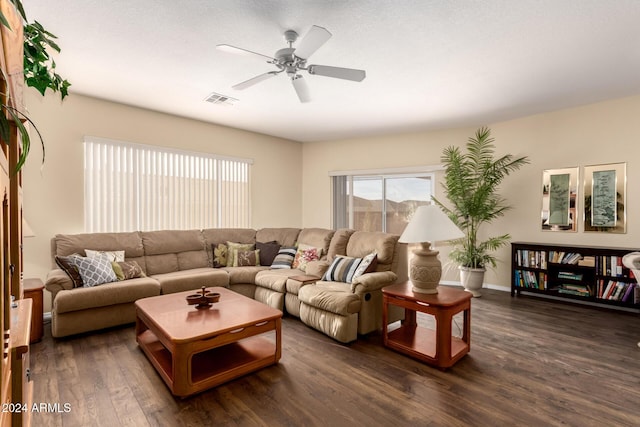 living room with ceiling fan and dark hardwood / wood-style flooring